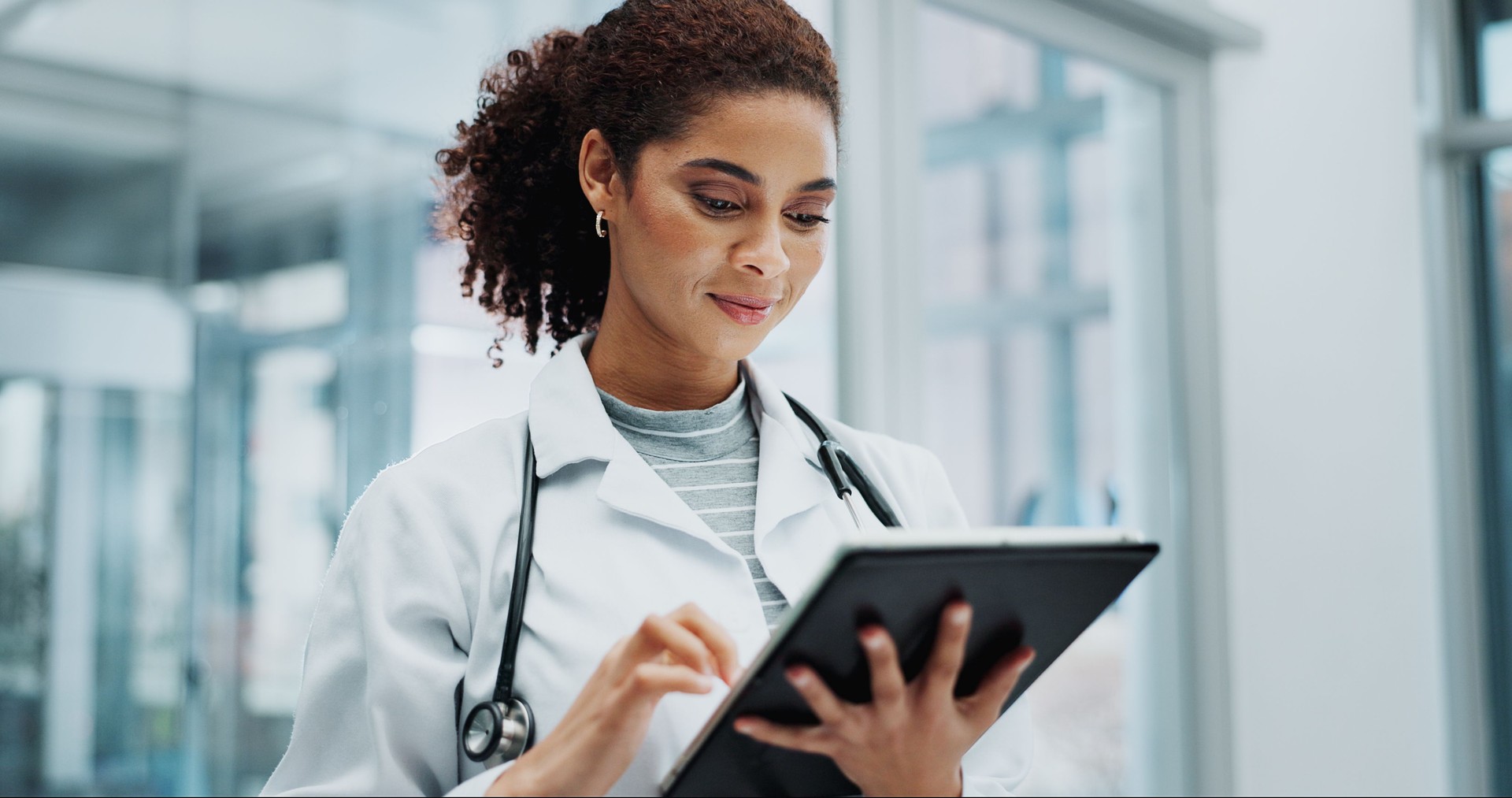 Tablet, woman and doctor with telehealth, networking and reading info at hospital with tech. Digital, research and online medical advice with clinic app for planning and results for web consultation